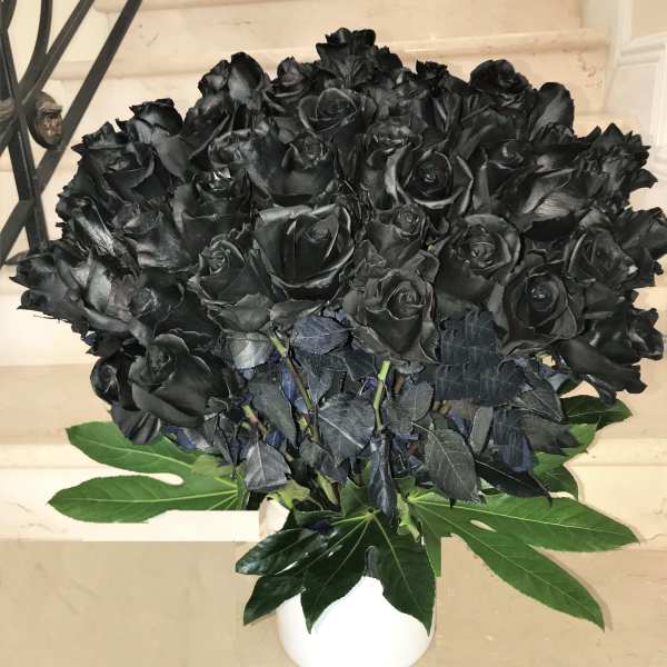 100 Black Roses arranged in a vase