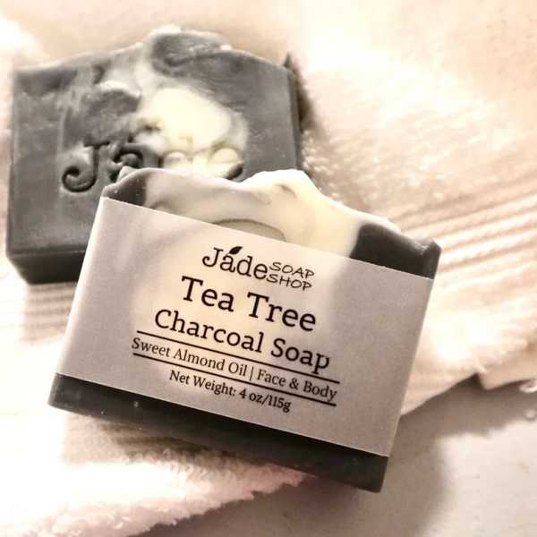 Black and white marbled tea tree charcoal soap bars on a white towel