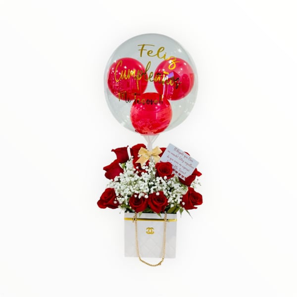 Red rose arrangement with white filler flowers in a gift box, topped with a clear birthday balloon