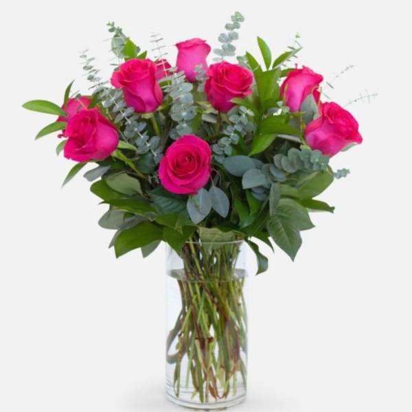 Dozen hot pink roses in a vase