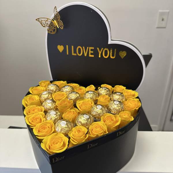 Large heart-shaped box with beautiful roses and Ferrero Rocher chocolates , Dior brand, with the phrase "I love you".
