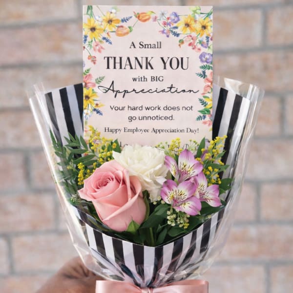 Small thank-you bouquet with pink rose, white carnation, and purple alstroemeria in striped wrap with card.