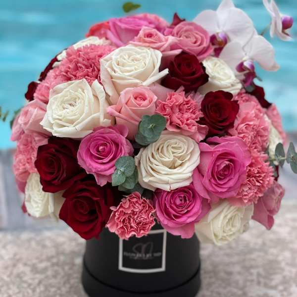 Roses, carnations, orchid and eucalyptus.