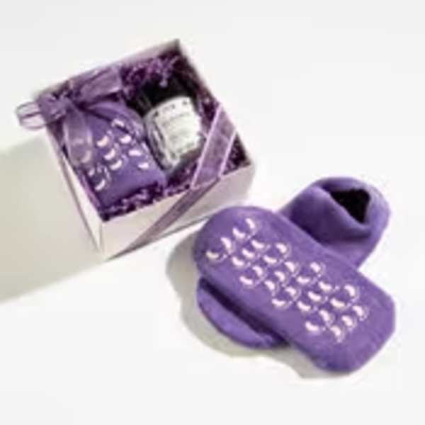 Purple spa gift set with grip socks, small jar, and pouch arranged in a ribboned box