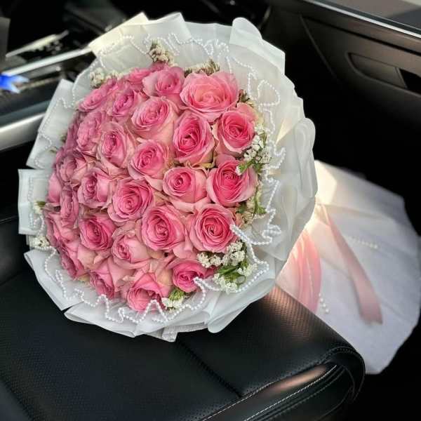 Pink rose bouquet with white wrapping