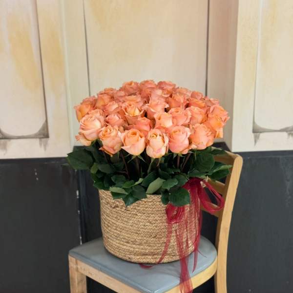 bouquet of fifty orange roses in a basket