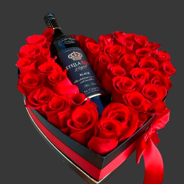 Red Roses in a Heart Shaped box with wine and chocolates.