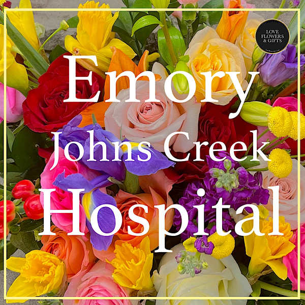 Colorful mixed bouquet with roses, irises, and yellow blooms behind hospital text overlay
