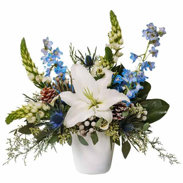 White lily arrangement with blue flowers in a white vase