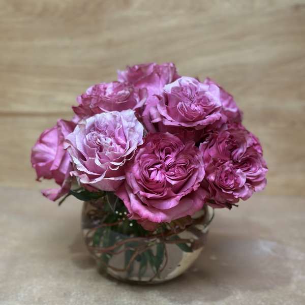 Pink roses arranged in a clear glass vase