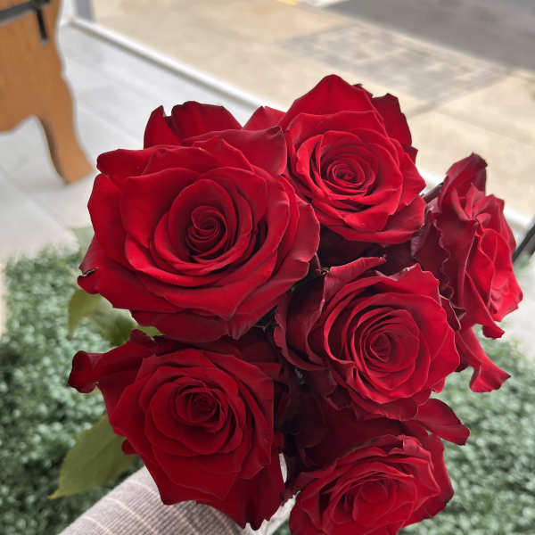 Handheld bouquet of red roses