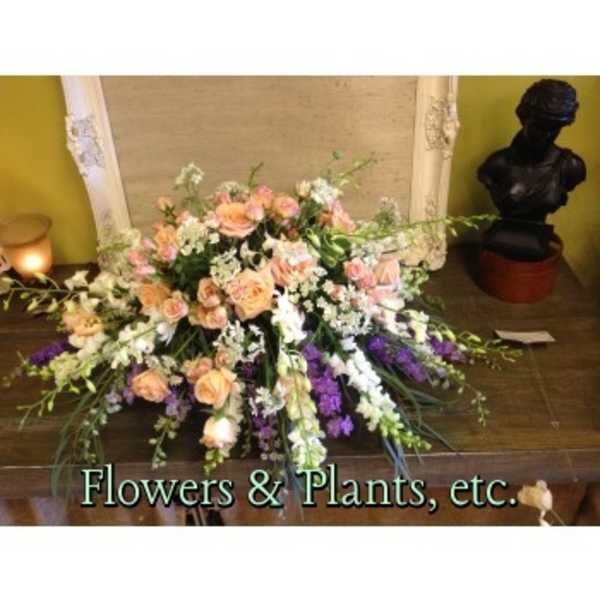 Large peach and white floral arrangement on a table