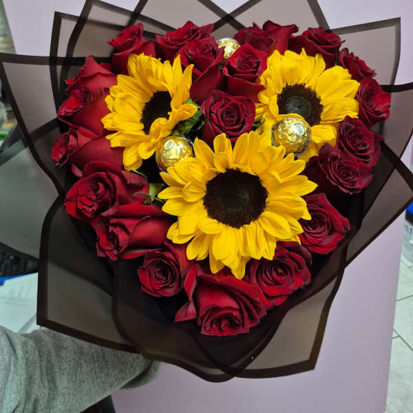 Sunflowers and roses in a heart-shaped bouquet.