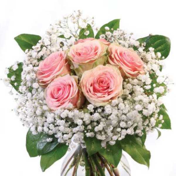 Round glass vase of pink roses surrounded by white filler flowers in a compact bouquet