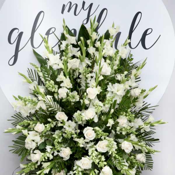 Large white floral standing spray on an easel