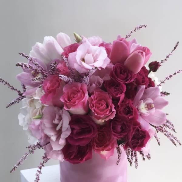 Pink and white bouquet of roses and tulips in a pink box