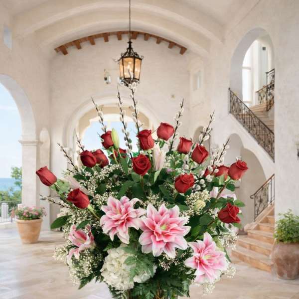 Tall vase arrangement with red roses and pink lilies