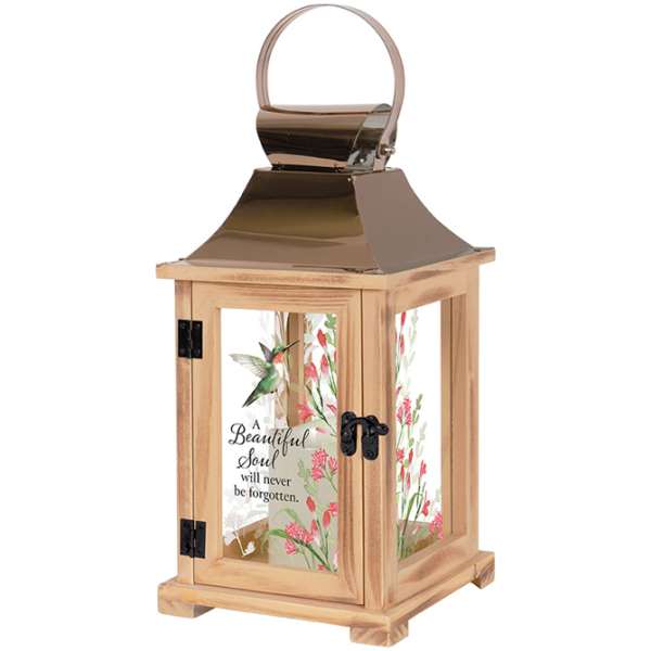 Wooden lantern with metal top and glass panels painted with a hummingbird, pink flowers, and memorial text.