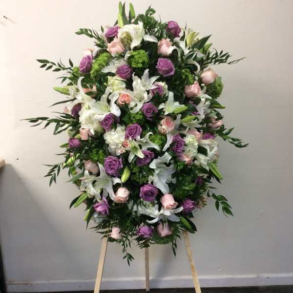 Large standing floral spray with pink, purple, and white flowers