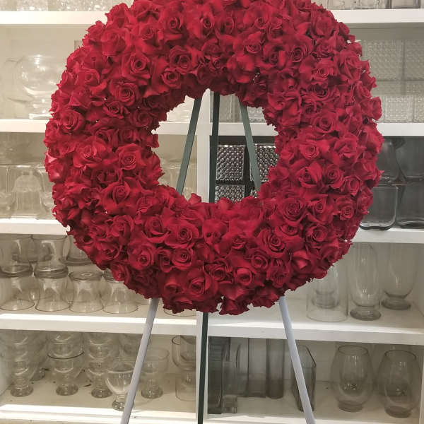 Large circular wreath of red roses on a stand