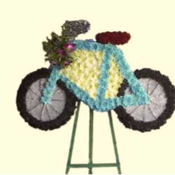 Flower-covered motorcycle sculpture on a stand