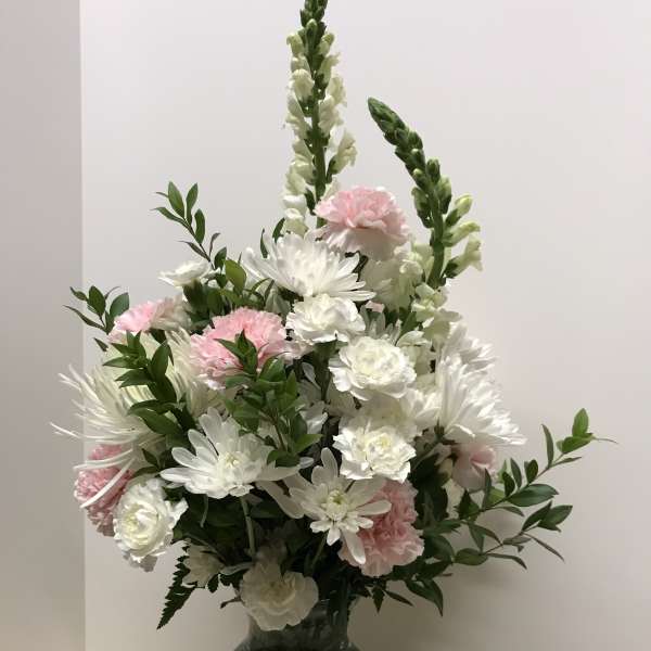 White and pink floral arrangement in a glass vase