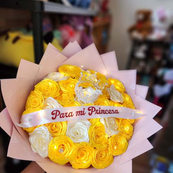 Yellow and white rose bouquet with a pink ribbon and crown topper