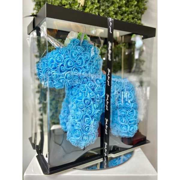 Blue artificial rose unicorn figure in a clear display box with black base and lid