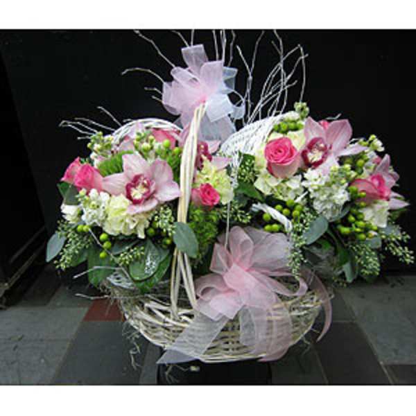 Pink and white floral basket arrangement with ribbon bows