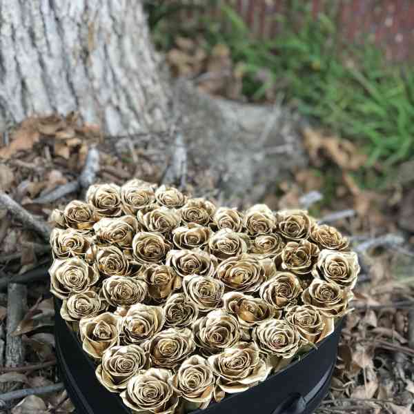Heart-shaped box filled with gold roses
