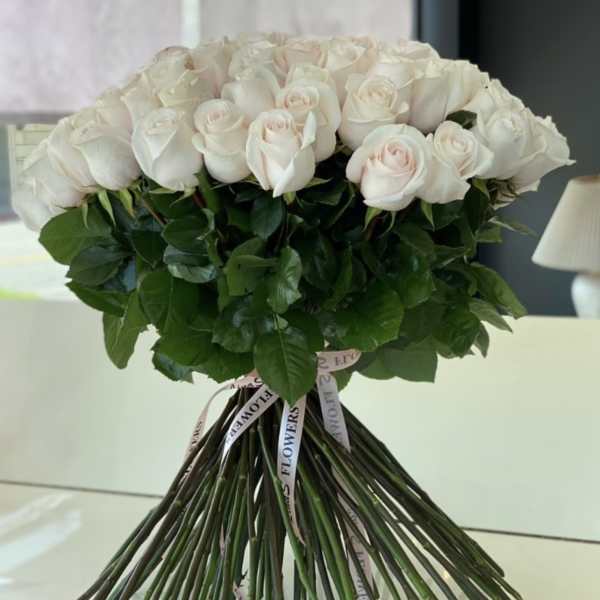 Bouquet of pale pink and white roses tied with ribbon