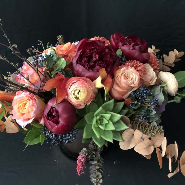 Mixed bouquet with pink and burgundy flowers and a green succulent