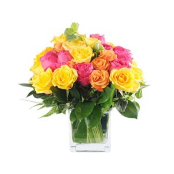 Bouquet of yellow, pink, and orange roses in a clear vase