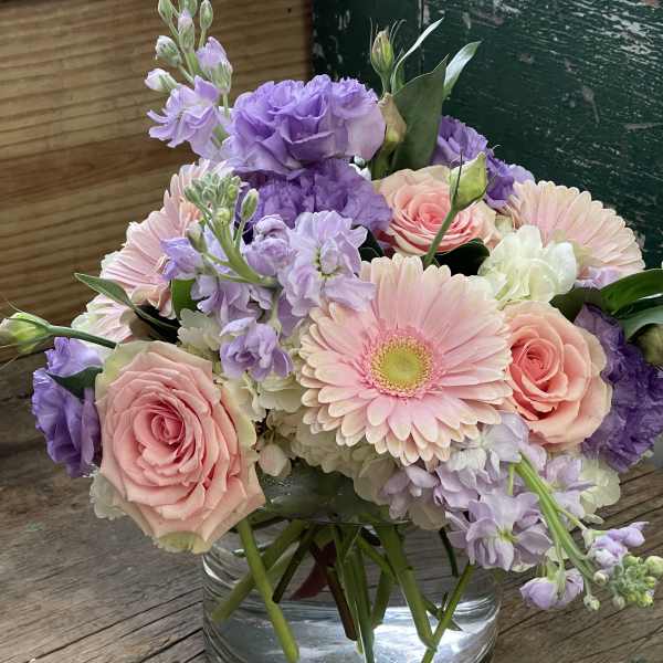 Pink and lavender bouquet in a clear glass vase