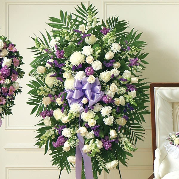 Large white and purple funeral spray with a lavender ribbon