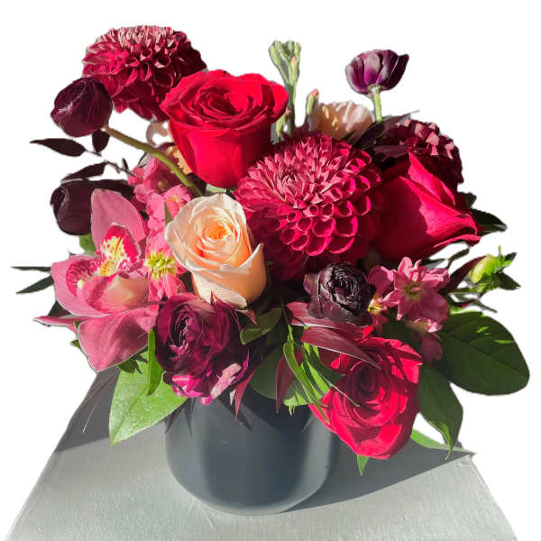 Bouquet of red and pink flowers in a black vase