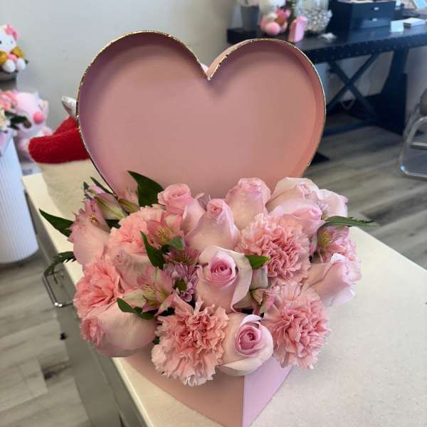 Pink rose and carnation arrangement in a heart-shaped box