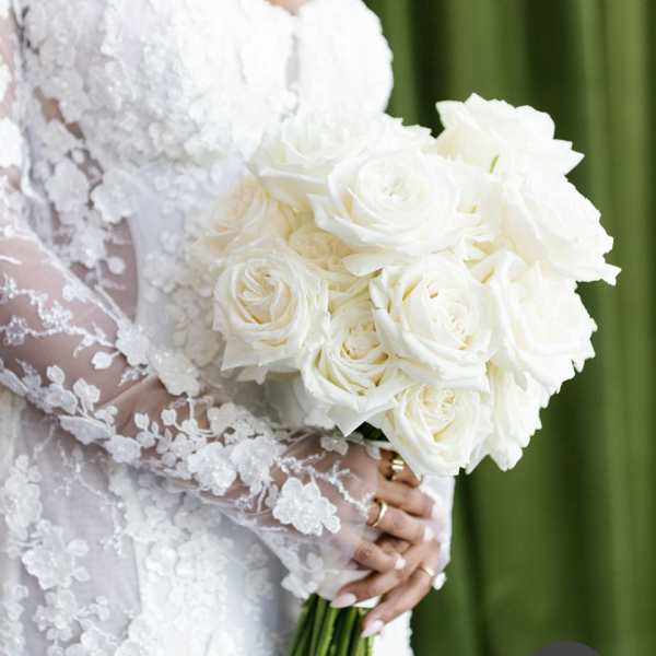 Bride holding a bouquet of white roses