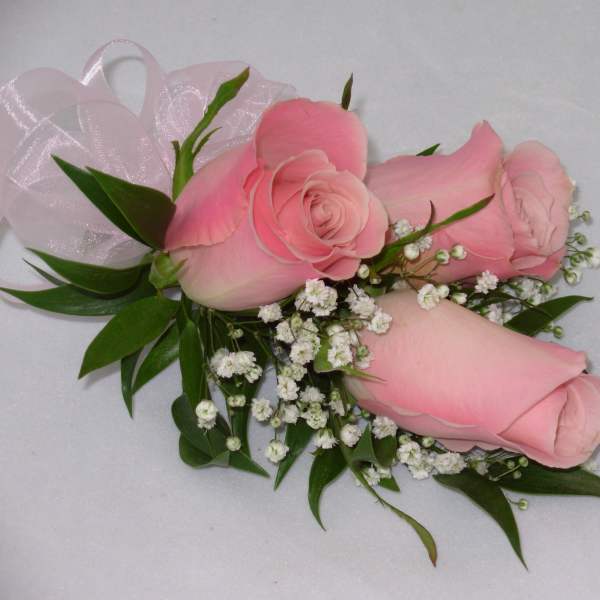Pink rose corsage with baby's breath and ribbon