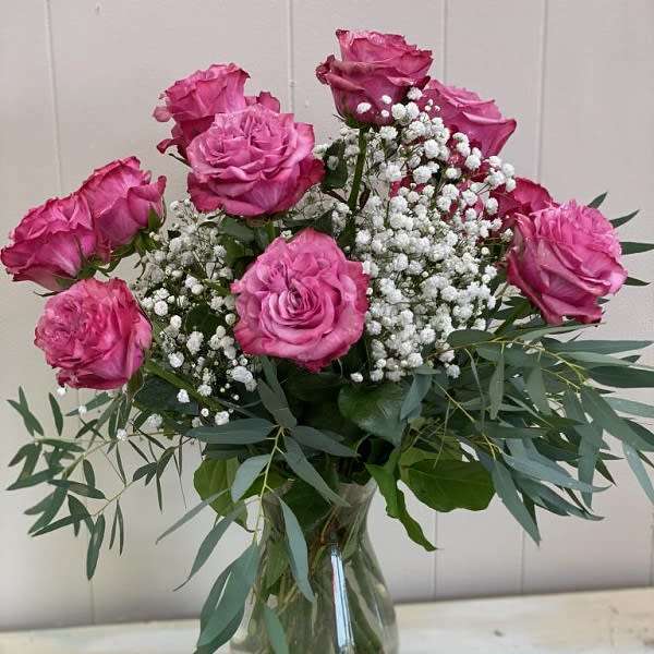 Pink roses and baby's breath in a clear glass vase