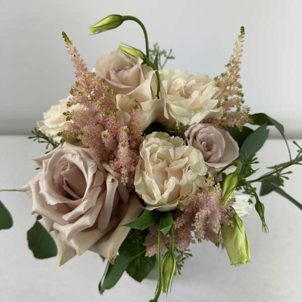 Bouquet of blush and cream roses with pink filler flowers