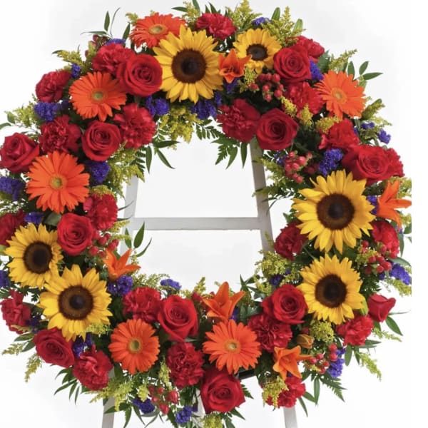 Colorful floral wreath with sunflowers, roses, and gerbera daisies