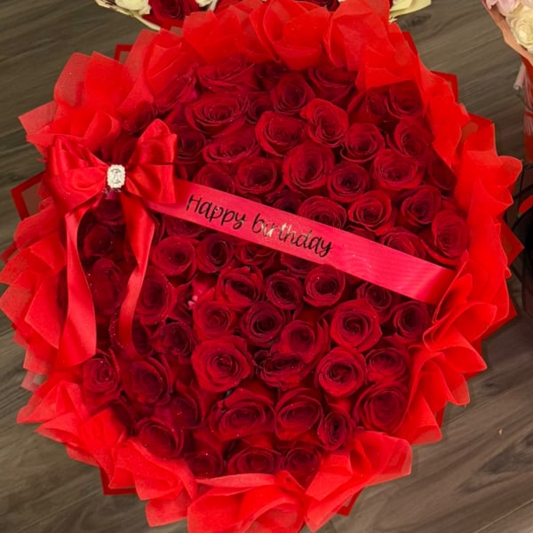 Large bouquet of red roses with a "Happy birthday" ribbon