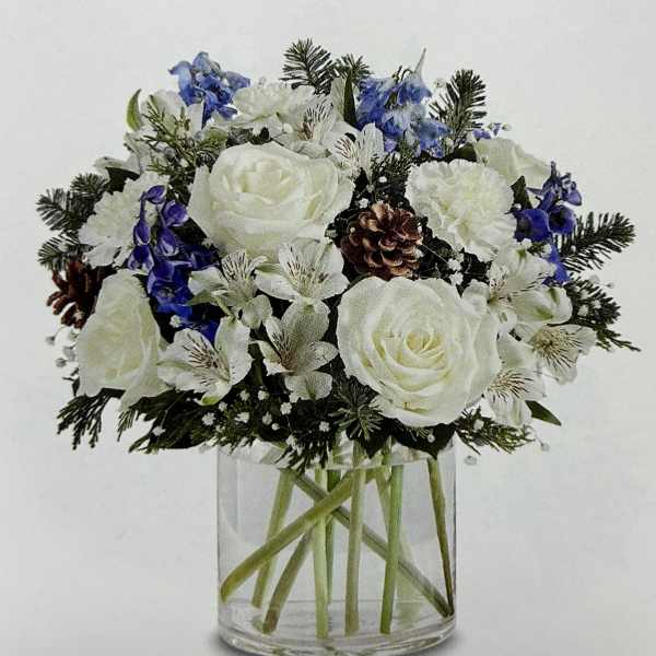 White and blue floral arrangement in a clear glass vase