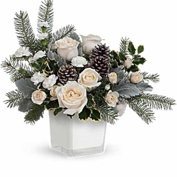 White roses and pinecones in a clear square vase
