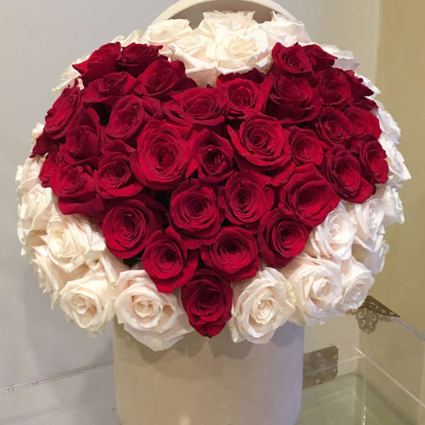 Heart-shaped bouquet of red and white roses in a white box