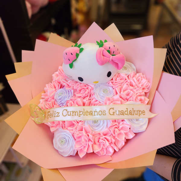 Pink bouquet with a Hello Kitty plush and a birthday ribbon