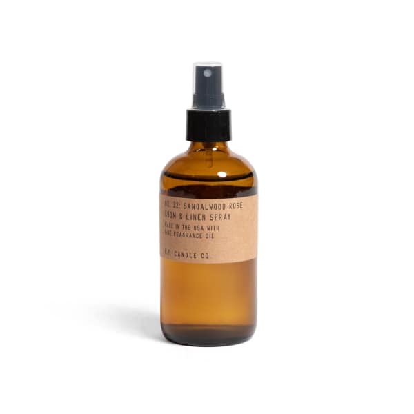 Amber spray bottle labeled sandalwood rose room and linen spray