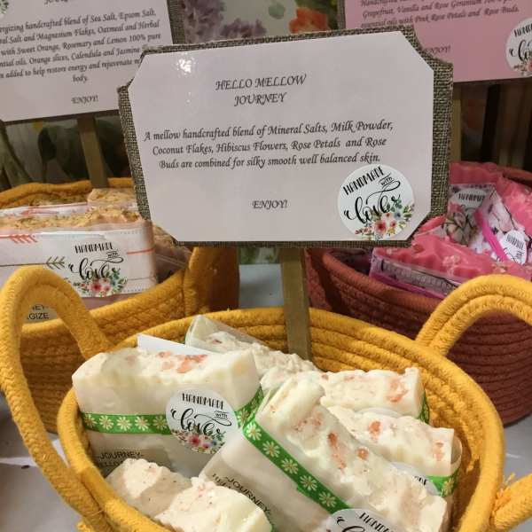 Basket of handmade soap bars with a product sign