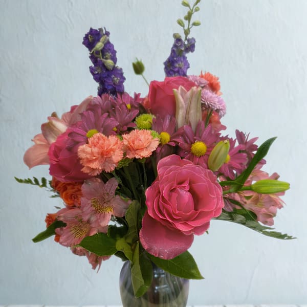 Pink and purple mixed bouquet in a glass vase